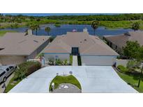 Charming single-story home with a well-manicured front yard and a driveway leading to an attached garage, near lake at 1433 Lake Marion Dr, Apopka, FL 32712