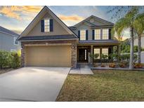 Two-story house with a large driveway and landscaped yard at 1624 Valmont Ln, Apopka, FL 32703