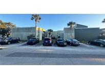 Exterior view of a condo building with ample parking at 197 Scottsdale Sq # 197, Winter Park, FL 32792