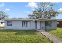 Newly renovated home with gray exterior, walkway, and grassy yard at 2441 Church St, Sanford, FL 32771