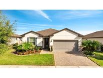 Single-story home with attractive landscaping and a two-car garage at 2724 Matera Dr, Saint Cloud, FL 34771