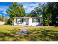 Charming home featuring a well-manicured lawn, inviting walkway, and tasteful landscaping at 2803 E Pine St, Orlando, FL 32803