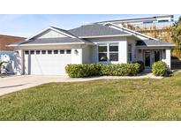 Newly built home with gray roof, white walls, and a two-car garage at 830 Hope Ave, New Smyrna Beach, FL 32169