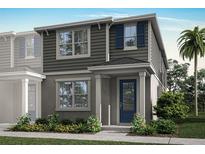 Two-story home with gray siding, blue door, and landscaping at 9843 Walkway Dr, Orlando, FL 32832