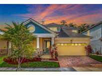 Beautiful two-story house with a two-car garage and landscaped front yard at 2487 Empress Dr, Kissimmee, FL 34741
