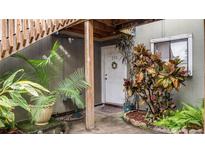 Inviting condo entry with lush landscaping at 293 Scottsdale Sq # 293, Winter Park, FL 32792
