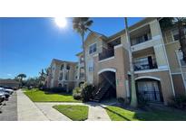Condo building with palm trees and ample parking at 3702 Palm Desert Ln # 5435, Orlando, FL 32839