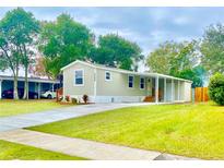 Nice manufactured home with covered carport and landscaped yard at 6668 Pompeii Rd, Orlando, FL 32822