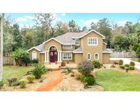 Two-story house with landscaped yard and walkway at 1437 Pecos Dr, Ormond Beach, FL 32174
