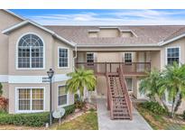 Two-story condo building with stairs and balconies at 2321 Prime Cir # B, Kissimmee, FL 34746
