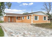 Updated single story home with new paint, landscaping, and a brick driveway at 4403 Brooke St, Orlando, FL 32811