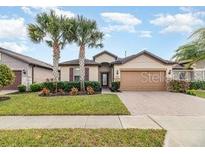 Single-Gathering home with a two-car garage and landscaped front yard at 672 Cordoba Dr, Davenport, FL 33837