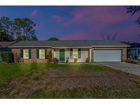 Brick ranch house with a two-car garage and well-maintained lawn at 762 S Edgemon Ave, Winter Springs, FL 32708