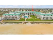 Aerial view of beachfront condo building with pool and ocean views at 815 Ocean Shore Blvd # U9A, Ormond Beach, FL 32176