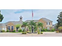 Elegant community clubhouse with fountain and landscaping at 940 Village Trl # 8-101, Port Orange, FL 32127
