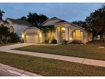 Attractive single-story home with landscaped yard and two-car garage at 10821 Oak Glen Cir, Orlando, FL 32817