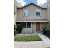 Two-story stucco home with a brown door and landscaping at 1009 Grove St # 90, Maitland, FL 32751