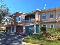 Two-story condo building with attached garages and balconies at 12021 Villanova Dr # 111, Orlando, FL 32837
