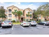 Condo building with parking lot and lush landscaping at 4881 Cypress Woods Dr # 3309, Orlando, FL 32811