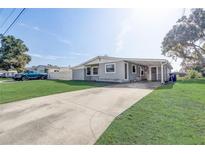 Gray house with a carport and a spacious yard at 1108 Evangeline Ave, Orlando, FL 32809