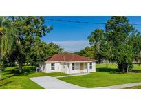 Newly constructed home with a well-manicured lawn and a paved driveway at 1526 Providence Rd, Lakeland, FL 33805