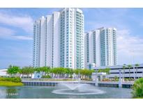 Luxury high-rise building with water fountain and landscaping at 241 Riverside Drive # 409, Daytona Beach, FL 32117