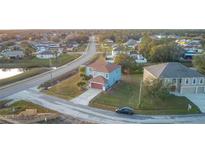 Aerial view of two-story house with attached garage, located in a residential neighborhood at 1001 Dampierre Ct, Kissimmee, FL 34759