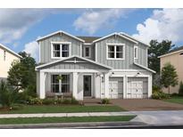 Two-story home with gray siding, white trim, and a two-car garage at 13106 Dendy Way # 19, Winter Garden, FL 34787