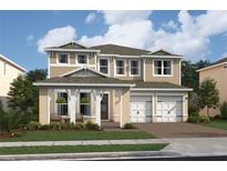 Two-story house with a beige exterior, two-car garage, and landscaping at 13171 Faro Ct # 31, Winter Garden, FL 34787