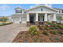 Charming two-story home with a welcoming front porch, manicured landscaping, and a two-car garage at 13200 Faro Ct # 44, Winter Garden, FL 34787
