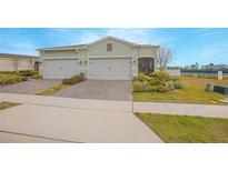 Charming single-story home featuring a two-car garage and beautifully landscaped front yard at 1987 Key Bay Trl, Kissimmee, FL 34747
