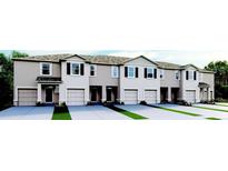 Three-story townhouses with attached garages and landscaping at 2223 Tongass Bnd, Davenport, FL 33896