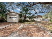 Home's exterior features a detached garage and grassy yard at 1 Black Jack Cir, Port Orange, FL 32128