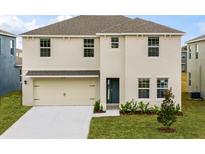 Two-story house with beige exterior, two-car garage, and landscaping at 1177 Alstonia Ln, Mount Dora, FL 32757