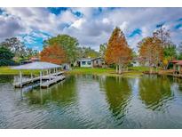 Lakefront property with dock and boathouse, offering serene water views at 1516 17Th Nw St, Winter Haven, FL 33881