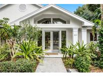 Inviting front entrance with lush landscaping and double doors at 1611 Walnut Ave, Winter Park, FL 32789