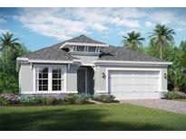 One-story home with gray exterior, white trim, and two-car garage at 2200 Seagrass Pt # 428, Kissimmee, FL 34747