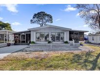 Inviting single-wide manufactured home with landscaped lawn and covered porch at 28 Da Rosa Ave, Debary, FL 32713