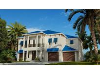 Two-story home with blue roof, two-car garage, and tropical landscaping at 749 S Atlantic S Ave, Ormond Beach, FL 32176