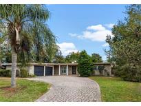 Attractive ranch home with circular driveway and mature landscaping at 958 Dunraven Dr, Winter Park, FL 32792