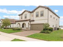 Two-story house with a neutral color scheme and a three-car garage at 11346 Lemon Lake Blvd, Orlando, FL 32836