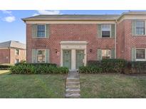 Brick front exterior of a charming two-story home with lush landscaping at 120 Georgetown Dr, Casselberry, FL 32707