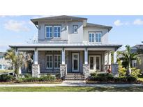 Two-story craftsman home with stone accents and metal roof at 13871 Briand Ave, Orlando, FL 32827