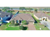 Beautiful single Gathering home featuring mature landscaping, attached two car garage, and brick paved driveway at 1855 Sugar Cove Ct, Ocoee, FL 34761