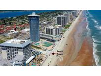 Stunning aerial view of the property with beach access, nearby hotels and beautiful coastline at 2626 S Atlantic Ave # 102, Daytona Beach Shores, FL 32118