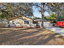 Single-story house with a large front yard and a two-car garage at 349 Hickory Dr, Maitland, FL 32751