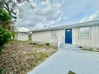 Charming single-story home featuring a bright blue front door and well-maintained exterior at 4510 Douglas St, Sanford, FL 32771