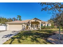 Beautiful single-story home with a large front yard and attached garage at 1715 Concert Rd, Deltona, FL 32738