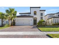 Two-story house with a two car garage and landscaped yard at 1861 Goblet Cove St, Kissimmee, FL 34746