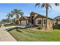 Well-maintained house with a two-car garage and attractive landscaping at 257 Bonville Dr, Davenport, FL 33897